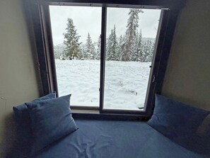 A room with a large window overlooking a snowy landscape with trees. - Wild Irishman 1074 - West Keystone - Easy Free Bus to Mountain + Hot Tub, Pool, Sauna (Keystone)