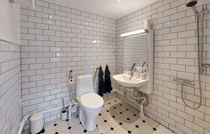 A bathroom with white subway tiles, a toilet, a sink, and a shower. - Lovely home in Sallerup with WiFi (Sallerup)