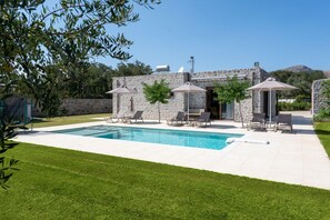 A stone villa with a swimming pool, outdoor seating, and a well-maintained lawn. - Villa Liatiko With Private Pool (Agios Vasileios)