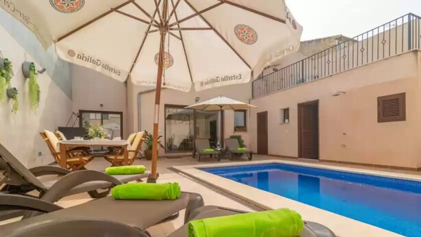 A poolside area with lounge chairs, a table, and umbrellas. - Villa Placeta - Villa With Private Pool. Free Wifi (, Illes Balears)