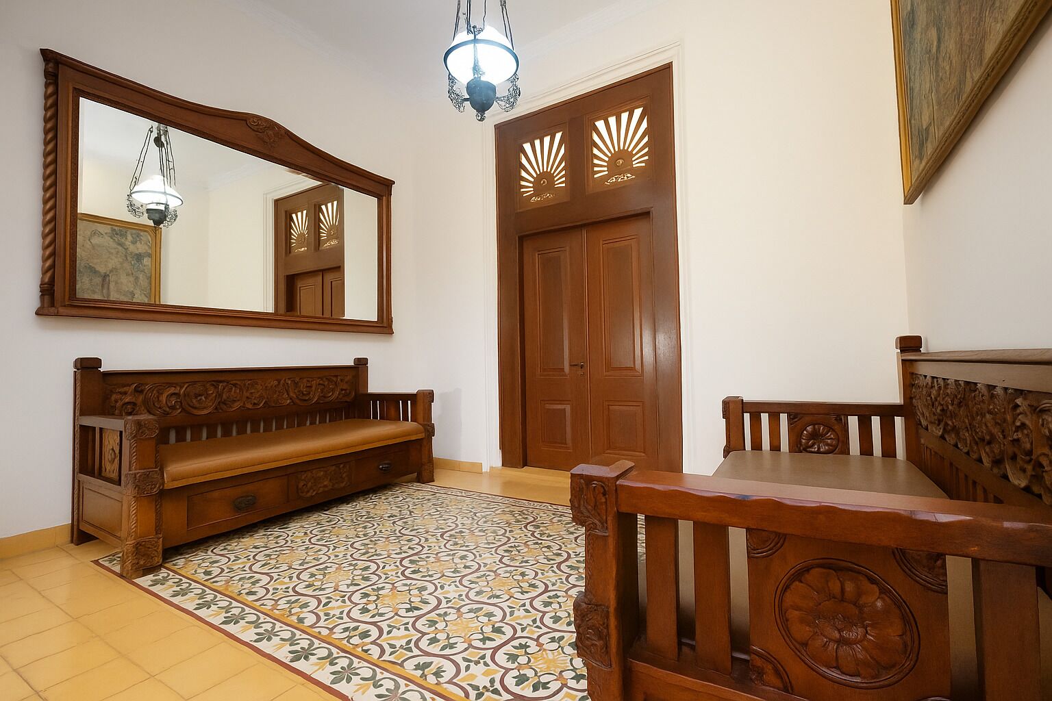 A room with a wooden bench, a dining table, a patterned rug, a large mirror, and a door with decorative cutouts.