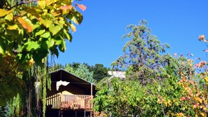 A wooden cabin with a balcony, surrounded by trees and a clear blue sky. - Studio in Marche With Pool Near Adriatic (Lapedona)