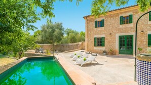 A stone building with a swimming pool, green shutters, and lounge chairs. - Son Paparra - Villa With Private Pool In Inca (Inca, Illes Balears)