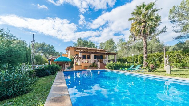 A swimming pool with a house in the background, surrounded by greenery. - Els Pins - Villa With Private Pool In Crestatx (Crestatx , Illes Balears)