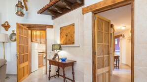 A hallway with wooden doors, a table with a bowl, and a lamp. - Hibiscus - Villa With Private Pool In Crestatx (Crestatx , Illes Balears)