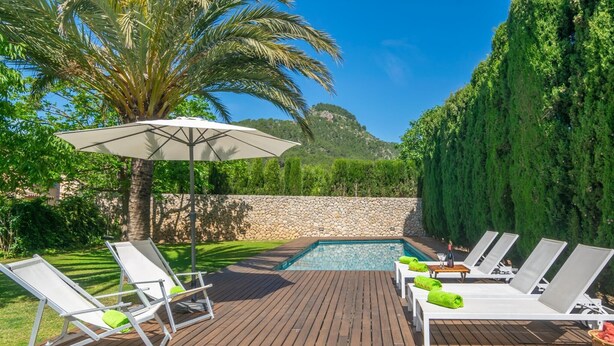 A wooden deck with lounge chairs and a pool. - Can Cabrit - Villa With Private Pool In Alaró (AlarÓ, Illes Balears)