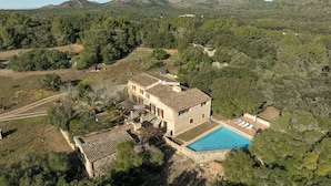 A stone villa with a swimming pool, surrounded by dense forest and hills. - Son Pastor - Villa With Private Pool In Artà (, Illes Balears)