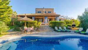 A poolside area with a stone house, outdoor seating, and a barbecue grill. - Can Reure (can Paris) - Villa With Private Pool (Inca, Illes Balears)
