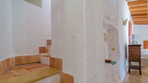 A staircase with terracotta steps leading to a room with white walls and a wooden ceiling. - Can Bolei - Villa With Private Pool In Sant Elm (Sant Elm (andratx), Illes Balears)
