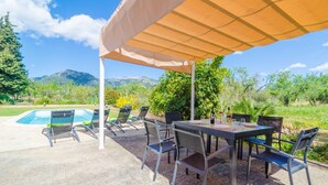 An outdoor patio with a pool, chairs, and a table under a canopy. - S'alqueria - Villa With Private Pool In Campanet (Campanet, Illes Balears)