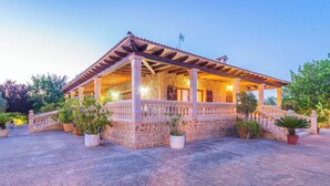 A stone building with a covered porch and potted plants. - Ca'n Berguins - Villa With Private Pool In Búger (Buger, Illes Balears)