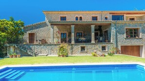 A stone house with a swimming pool, a covered patio, and a staircase leading to the entrance. - Turixant Dalt - Villa With Private Pool. Free Wifi (Mancor De La Vall, Illes Balears)