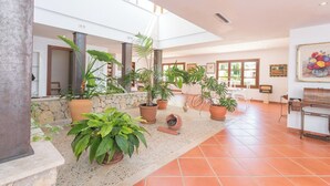 A spacious indoor area with multiple potted plants, a piano, and framed artwork on the walls. - Turixant Dalt - Villa With Private Pool. Free Wifi (Mancor De La Vall, Illes Balears)