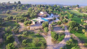 A villa with a swimming pool, surrounded by lush greenery and fields. - Son Vador - Villa With Private Pool. Free Wifi (Santa Margalida, Illes Balears)