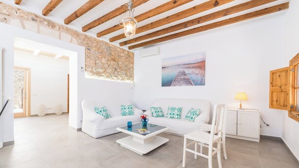 A spacious living room with a white sofa, a coffee table, and a wooden cabinet. - Can Diana - Villa With Private Pool In Campanet (Campanet, Illes Balears)