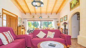 A living room with two pink sofas, a wooden ceiling, and a view of greenery outside. - Es Blanquer De Na Fani - Villa With Private Pool (Binissalem, Illes Balears)