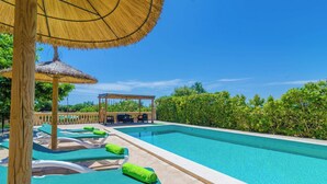 A clear blue swimming pool with lounge chairs and umbrellas, surrounded by greenery. - Sa Cova (cova De Rotana) - Villa With Private Pool (Manacor, Illes Balears)