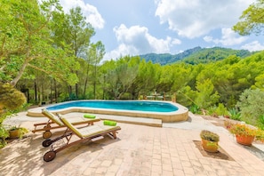 A swimming pool with lounge chairs, surrounded by trees and a mountainous backdrop. - Casa Mas - Villa With Private Pool In Felanitx (Felanitx, Illes Balears)