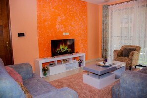 Family Apartment, Balcony, City View | Living area | 24-inch Smart TV with digital channels