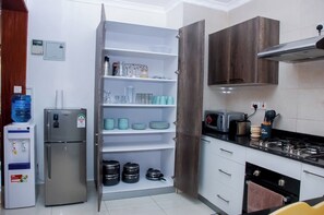 Apartment, Balcony, City View | Private kitchen | Fridge, microwave, cookware/dishes/utensils, dining tables - Amalia Apartments Syokimau (Syokimau)