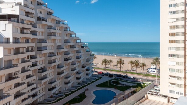 A high-rise hotel with multiple balconies, a swimming pool, and a beach view. - Torres Del Mar - Apartment In Grau I Platja (Playa De Gandia, Valencia)