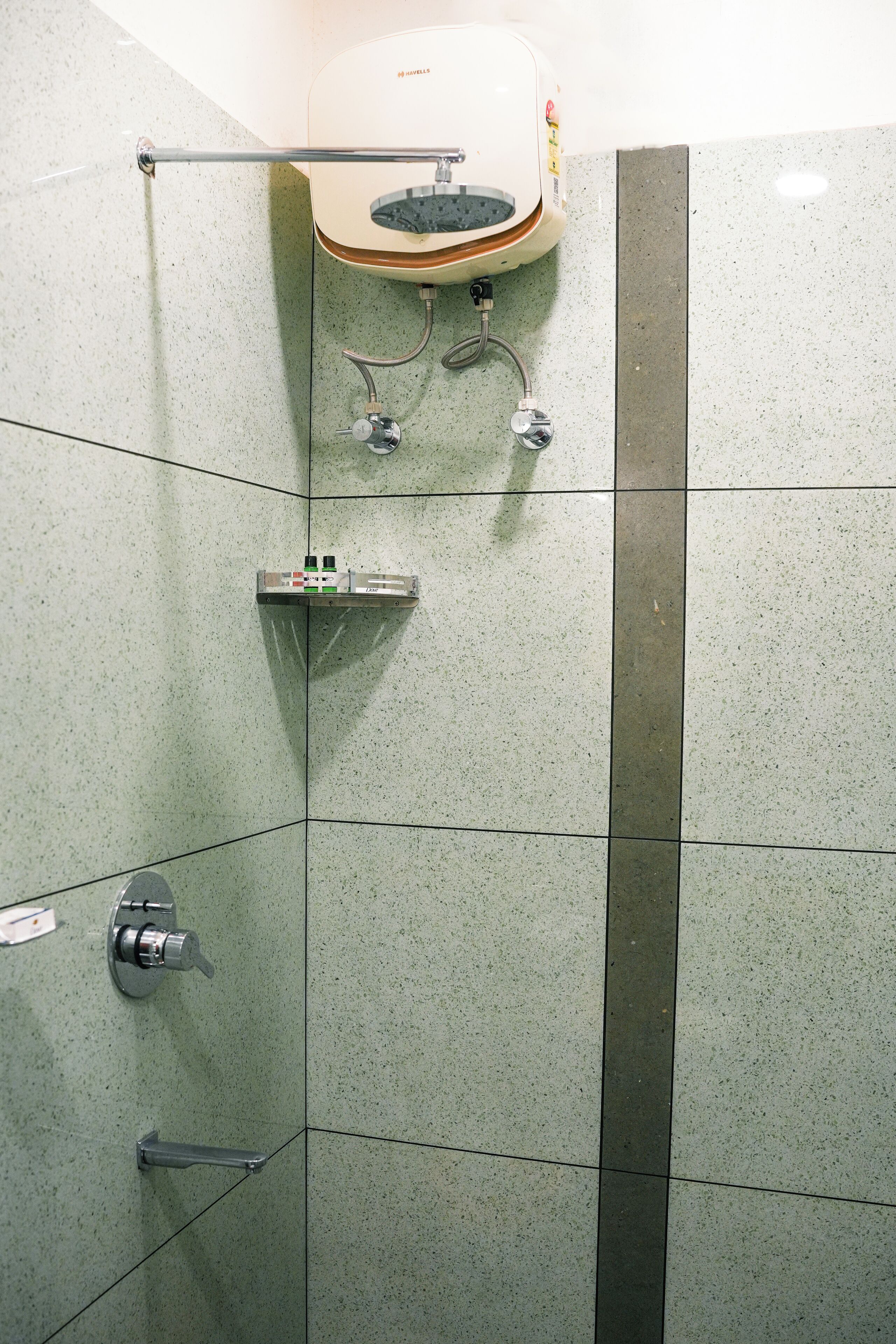 A bathroom with a shower, a sink, and a toilet.