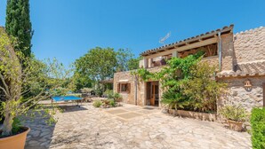 A stone courtyard with a pool, surrounded by potted plants and trees. - Can Sua - Villa With Private Pool In Artà (Artà, Illes Balears)