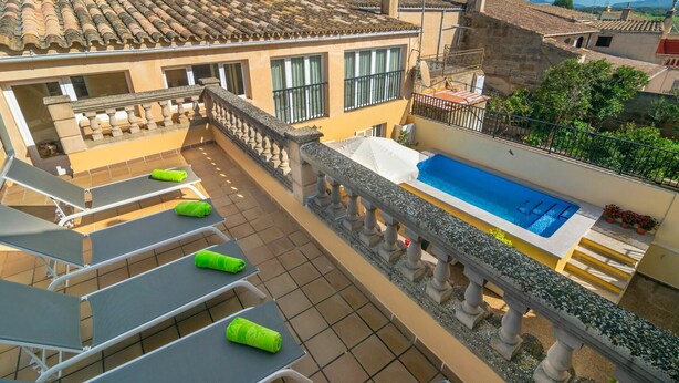 A rooftop terrace with a swimming pool, lounge chairs, and a stone balustrade. - Unio 36 - Villa With Private Pool In Ariany (Ariany, Illes Balears)