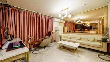 D - Luxury Suite, 2 Queen Beds, Balcony, City View | Living area | 65-inch LED TV with cable channels, Netflix, computer