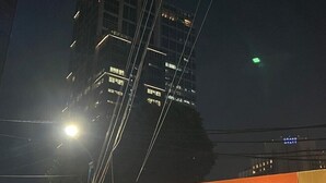 A sign for KOSTKAN HOUSE with a modern design and a view of a tall building in the background. - Kostkan House (Jakarta)