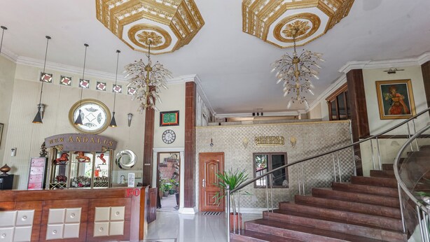 A grand lobby with a reception desk, a staircase, and a decorative ceiling. - Collection O Puncak Bogor Near Taman Safari Indonesia Formerly Hotel Andalus (Megamendung)