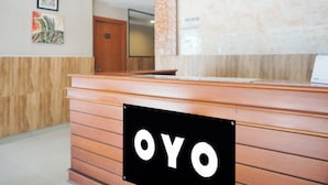 A reception desk with a sign that reads "OYO". - Collection O Bukit Kecil Near Palembang Indah Mall  Formerly Hostel 77 (Palembang)