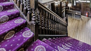 A multi-level wooden staircase with ornate balusters and purple carpeted steps. - Mansion by the Sea, 12BR/12BA, Perfect for Events (Bournemouth)