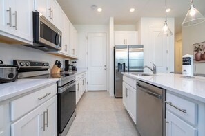 Fridge, dishwasher, coffee/tea maker, cookware/dishes/utensils