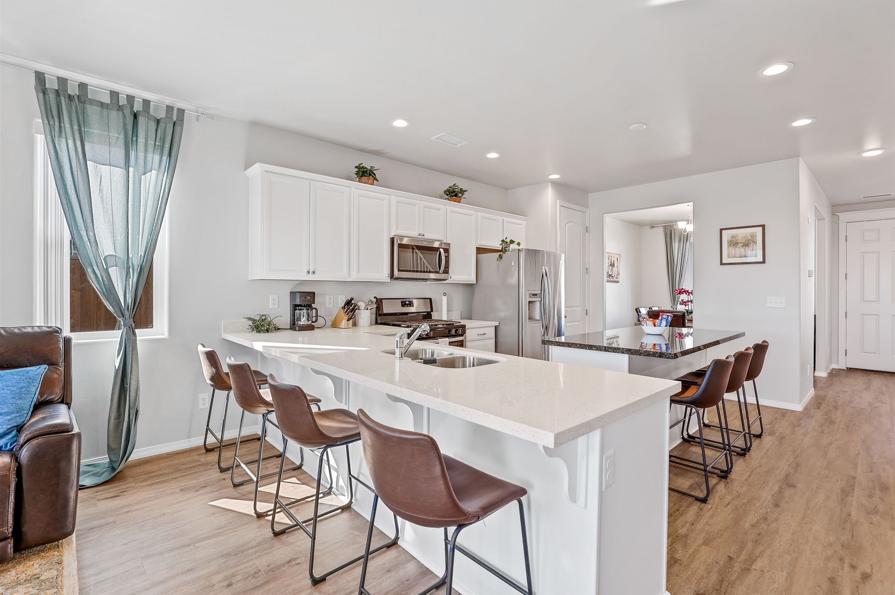 The kitchen is also home to two bar counter tops with 3 and 4 barstools, allowing for extra seating for 7.