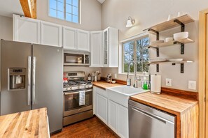 Enjoy cooking in this well-equipped kitchen with a refrigerator, oven, and dishwasher.