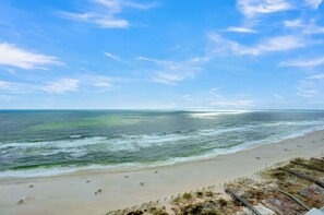 A beach with a clear sky and ocean waves.