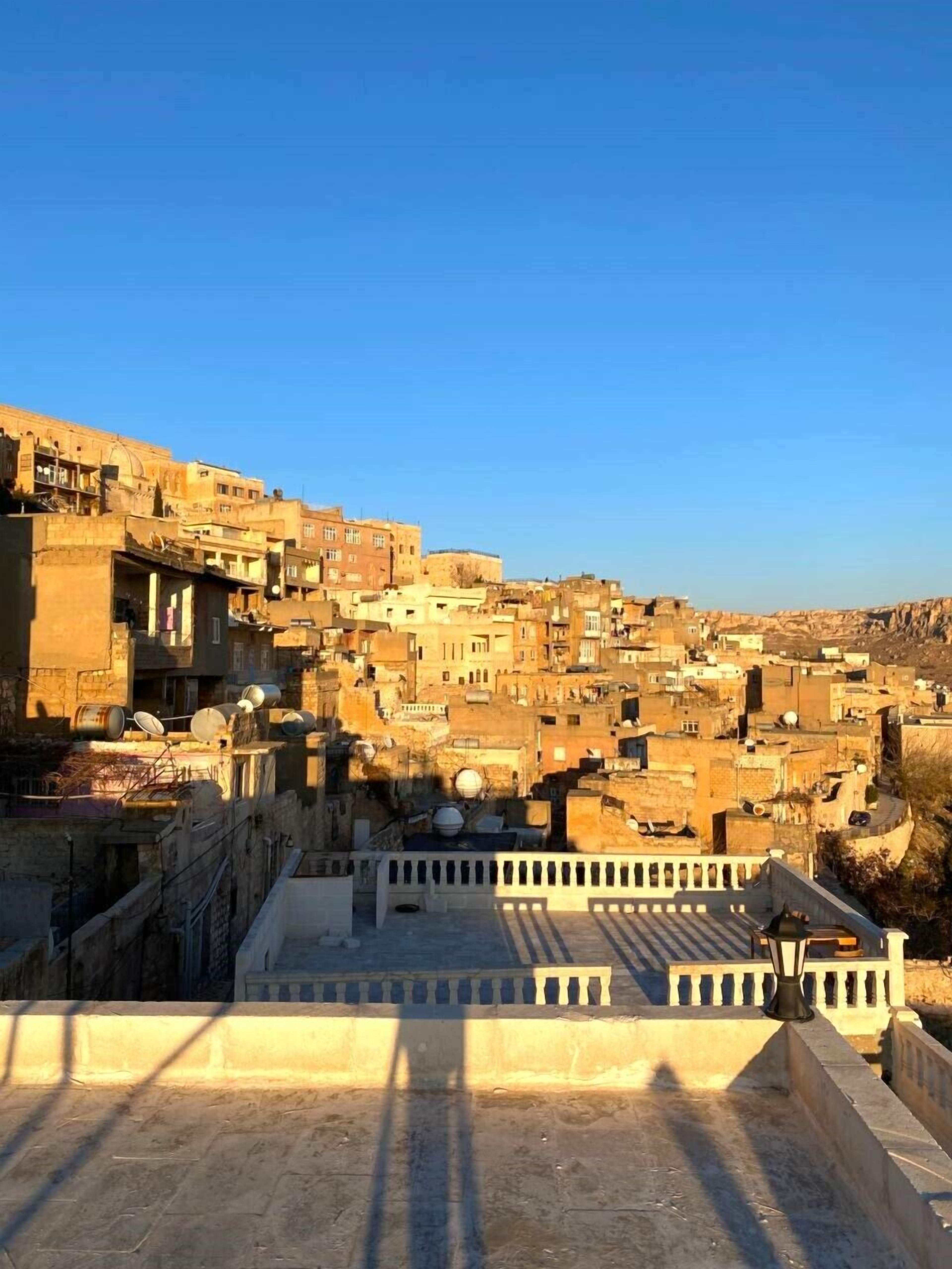 A densely packed urban area with traditional architecture, featuring a prominent building with a dome and a balcony.