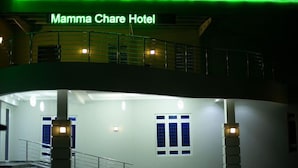 The Mamma Chare Hotel's interior with a staircase, a balcony, and a sign above the entrance. - Mamma Chare Hotel  (Jimeta)