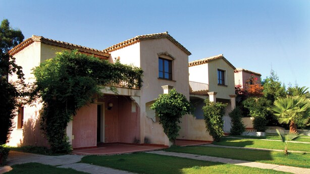 A two-story house with a red door and a small front yard. - Classical Residence Baia Delle Palme 2 Bedroom Apartment Sleeps 6 Persons T6 (Pula)