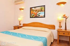 A hotel room with a bed, two bedside tables with lamps, a framed picture on the wall, and a tiled floor. - Classical Residence Baia Delle Palme 2 Bedroom Apartment Sleeps 6 Persons T6 (Pula)