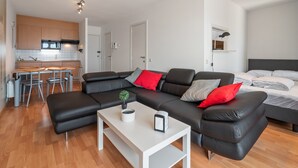 A modern apartment with a living area, kitchen, and bedroom. - One-bedroom Flat With sea Views and Parking (Blankenberge)