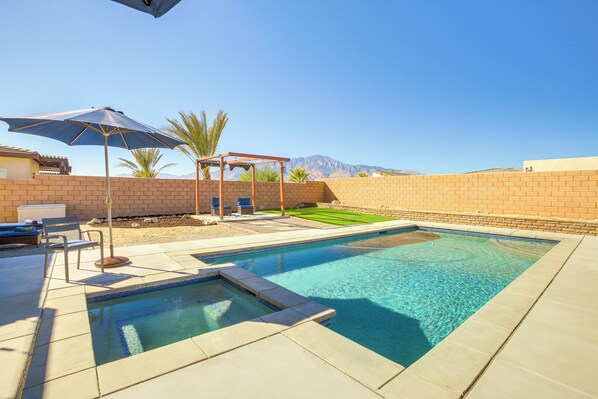 A rectangular swimming pool with a clear blue water feature, surrounded by a tiled deck. - Pool, Spa & More: Relax in Desert Hot Springs! (Desert Hot Springs)