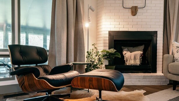 A modern living room with a leather sofa, a wooden coffee table, and a fireplace. - Hammock House at Bella Vista (Bella Vista)