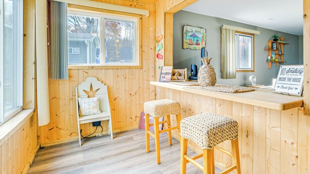 A wooden interior with a bar area, a bench, and a sign. - Steps to Long Lake: Cabin w/ Patio in Harrison! (Harrison)