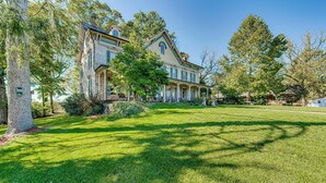 A large, two-story house with a prominent porch and a well-maintained lawn. - Walk to Creek: Mount Joy Home Near Nook Sports (Mount Joy)