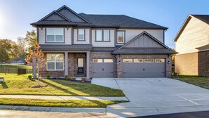 A two-story house with a garage, a front yard with a small tree, and a clear sky. - 4 Mi to Dtwn: Danville Home w/ Patio & Yard (Danville)