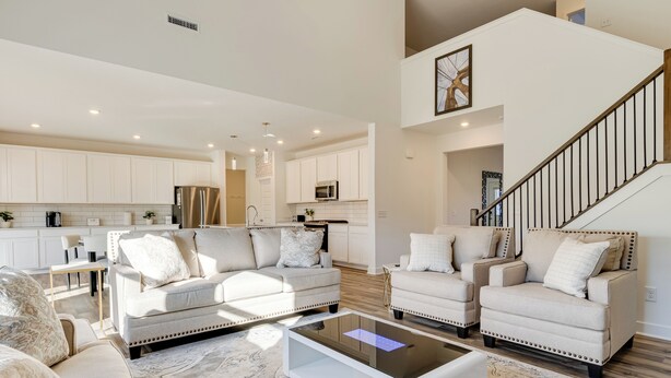 A spacious living area with a modern kitchen, two sofas, a coffee table, and a staircase. - 4 Mi to Dtwn: Danville Home w/ Patio & Yard (Danville)
