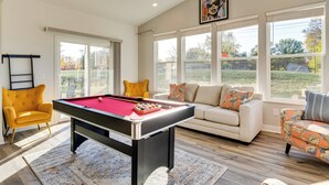 A pool table in a well-lit room with large windows, a yellow armchair, and a white sofa with colorful cushions. - 4 Mi to Dtwn: Danville Home w/ Patio & Yard (Danville)