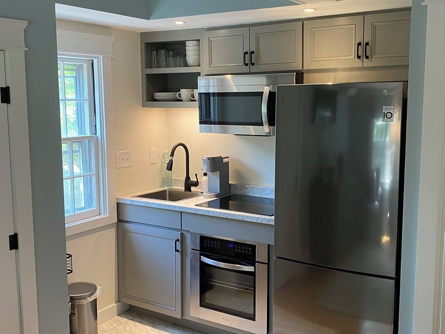 A modern kitchen with stainless steel appliances, a built-in microwave, and a dishwasher.
